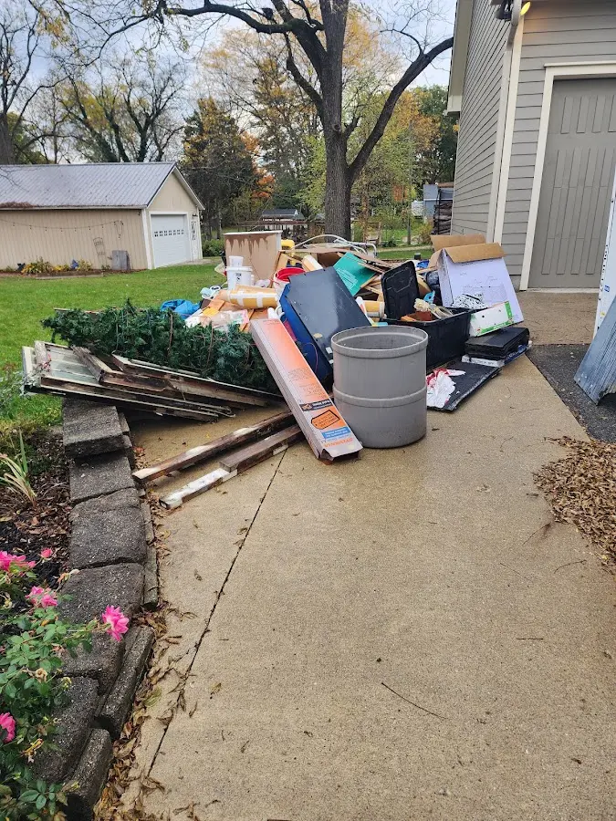 Dumpster being loaded with debris for Estate Cleanout Dumpster Rental in Island Lake